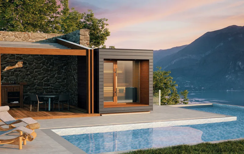 A compact sauna on a terrace above a mountain lake